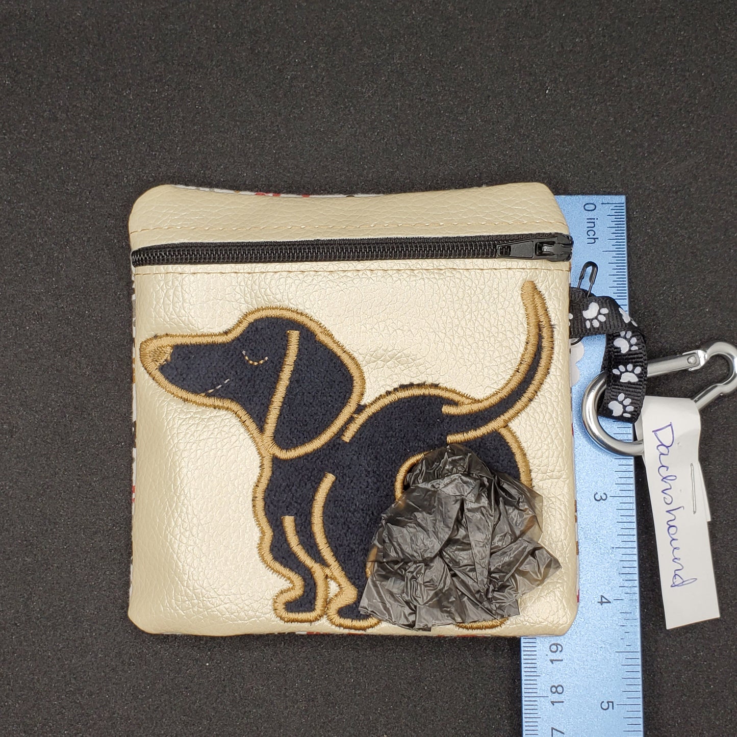Dachshund -black dog, tan outline and light colored bag- Pet Poo/waste bag holder